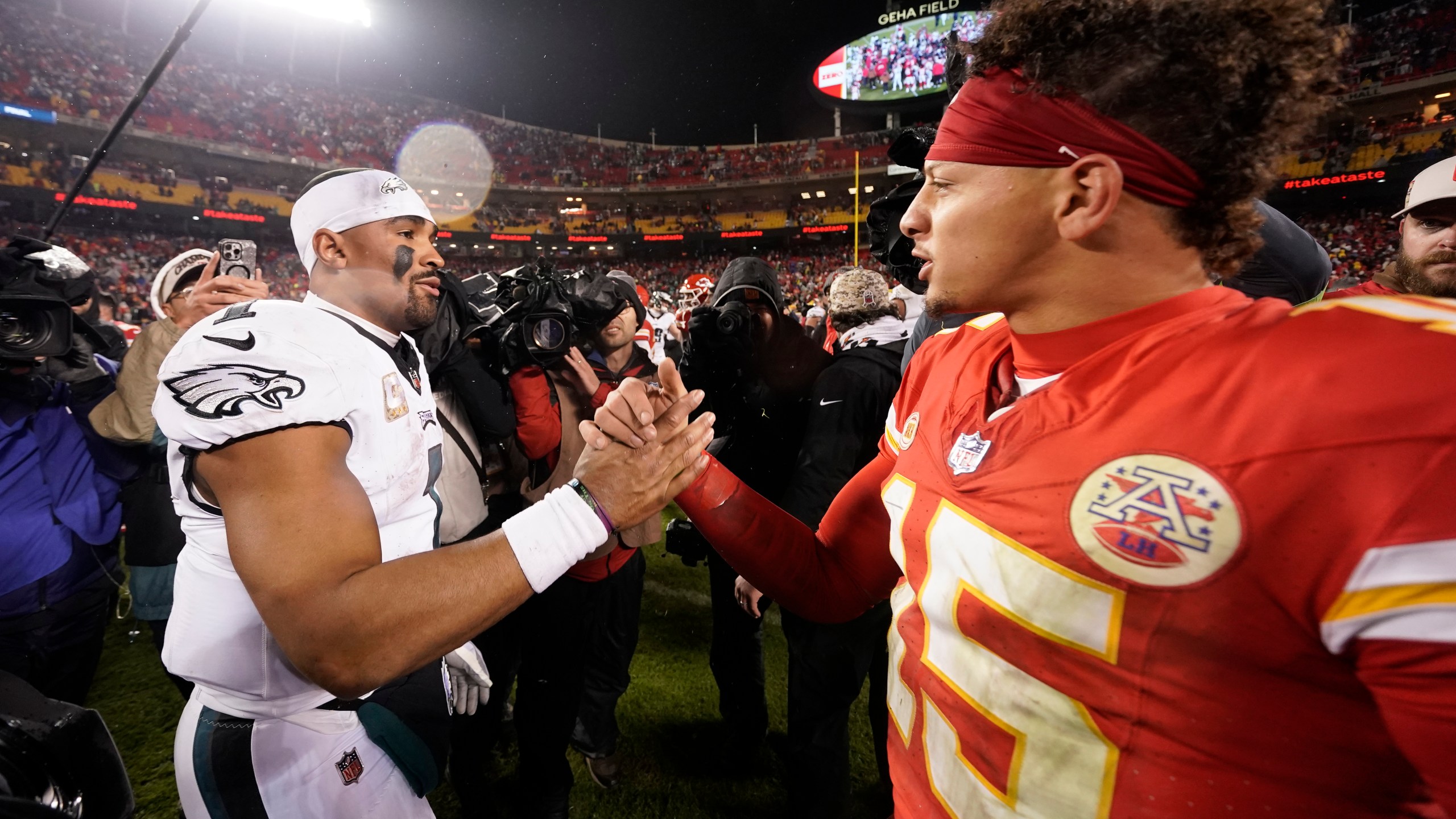 FILE- Philadelphia Eagles quarterback Jalen Hurts, left, and Kansas City Chiefs quarterback Patrick Mahomes (15) shake hands following an NFL football game on Monday, Nov. 20, 2023, in Kansas City, Mo. (AP Photo/Charlie Riedel, File)