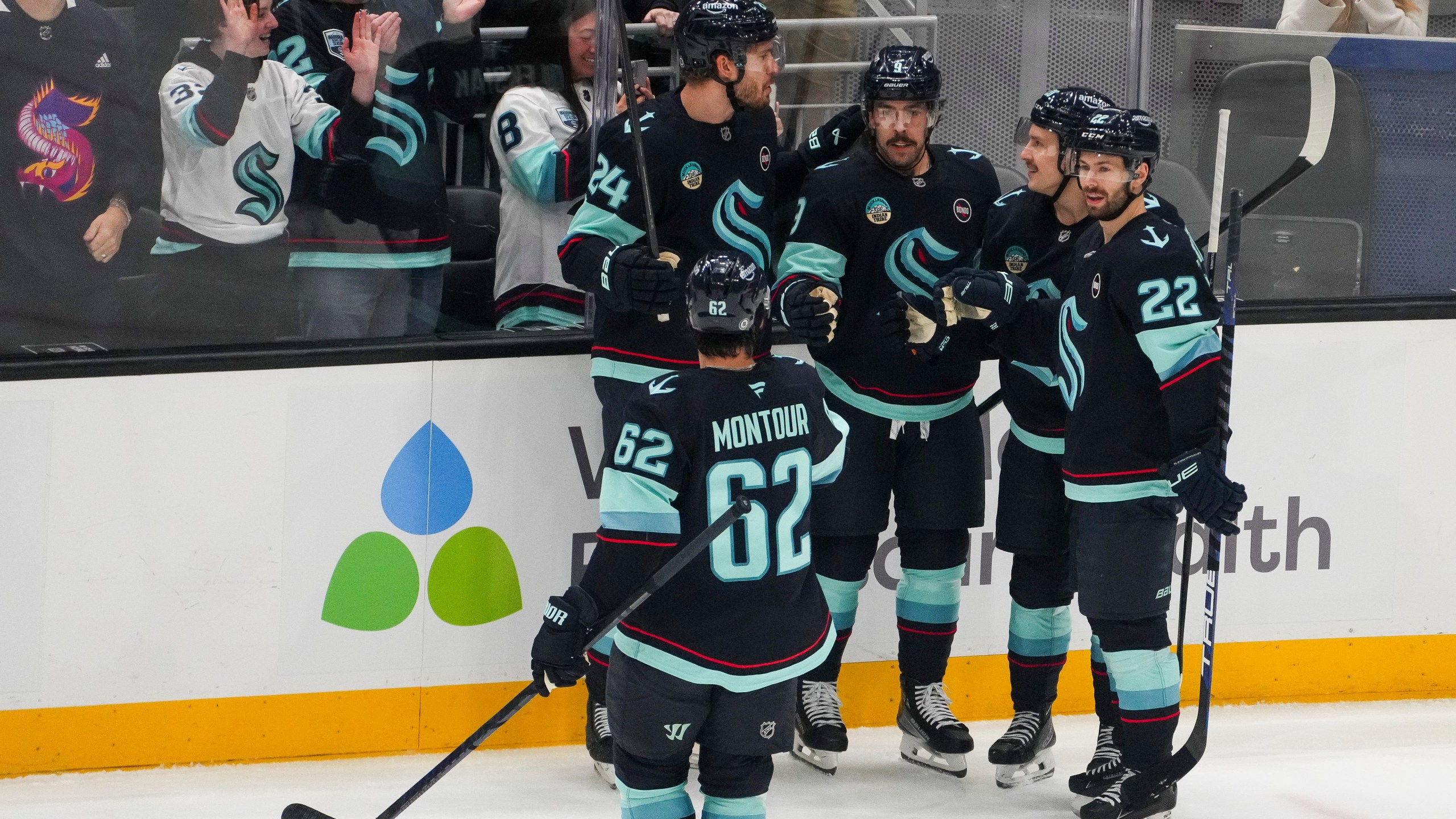 Seattle Kraken center Chandler Stephenson, third from left, celebrates his goal against the San Jose Sharks with teammates Brandon Montour (62), Jamie Oleksiak (24), Eeli Tolvanen and Oliver Bjorkstrand (22) during the first period of an NHL hockey game Thursday, Jan. 30, 2025, in Seattle. (AP Photo/Lindsey Wasson)