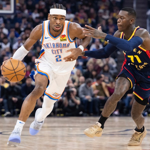 Golden State Warriors guard Dennis Schröder (71) defends against Oklahoma City Thunder guard Shai Gilgeous-Alexander during the first half of an NBA basketball game Wednesday, Jan. 29, 2025, in San Francisco. (AP Photo/Benjamin Fanjoy)