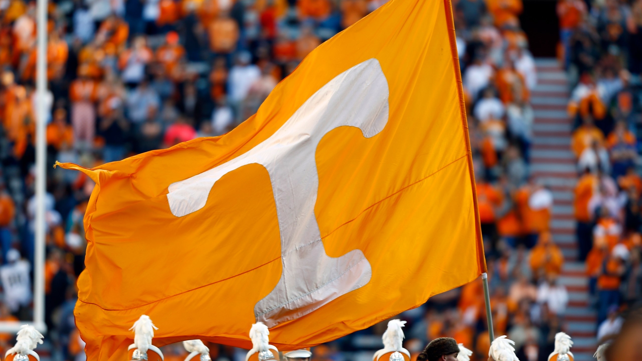 FILE - A Tennessee cheerleader runs with a flag before an NCAA college football game against Vanderbilt, Nov. 25, 2017, in Knoxville, Tenn. (AP Photo/Wade Payne, File)