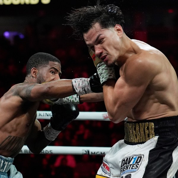 Stephen Fulton Jr., left, hits Brandon Figueroa in a featherweight title boxing match Saturday, Feb. 1, 2025, in Las Vegas. (AP Photo/John Locher)