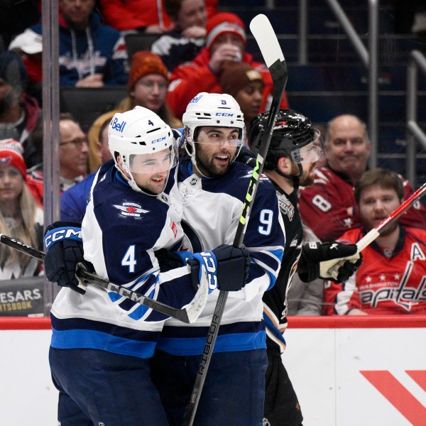 Winnipeg Jets left wing Alex Iafallo (9) celebrates his goal with defenseman Neal Pionk (4) during the second period of an NHL hockey game against the Washington Capitals, Saturday, Feb. 1, 2025, in Washington. (AP Photo/Nick Wass)