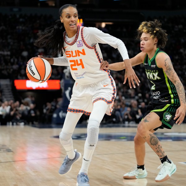 FILE - Connecticut Sun forward DeWanna Bonner (24) works toward the basket as Minnesota Lynx guard Natisha Hiedeman (2) defends during the first half of Game 5 of a WNBA basketball semifinals, on Oct. 8, 2024, in Minneapolis. (AP Photo/Abbie Parr, File)