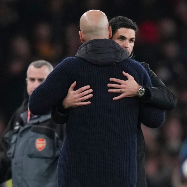 Arsenal's manager Mikel Arteta, background, hugs Manchester City's head coach Pep Guardiola at the end of the English Premier League soccer match between Arsenal and Manchester City at the Emirates stadium in London, Sunday, Feb. 2, 2025. (AP Photo/Alastair Grant)