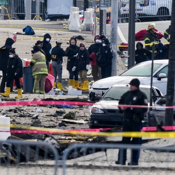 Investigators work the scene after a small plane crashed in Philadelphia, Saturday, Feb. 1, 2025. (AP Photo/Matt Rourke)