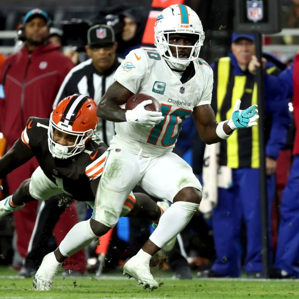 Miami Dolphins wide receiver Tyreek Hill (10) runs past Cleveland Browns safety Juan Thornhill (1) during an NFL football game, Sunday, Dec. 29, 2024, in Cleveland. (AP Photo/Kirk Irwin)