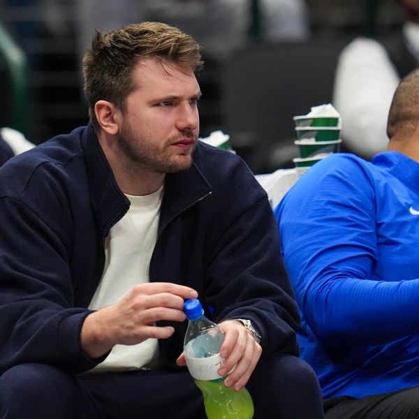 Dallas Mavericks guard Luka Doncic looks on from the bench during the second half of an NBA basketball game against the Denver Nuggets, Sunday, Jan. 12, 2025, in Dallas. The Nuggets won 112-101. (AP Photo/Julio Cortez)