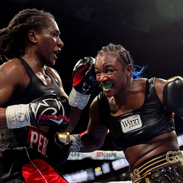 Claressa Shields, right, exchanges punches with Danielle Perkins during the undisputed heavyweight title match on Sunday, Feb. 2, 2025 at Dort Financial Center in Flint. (Jake May/The Flint Journal via AP)