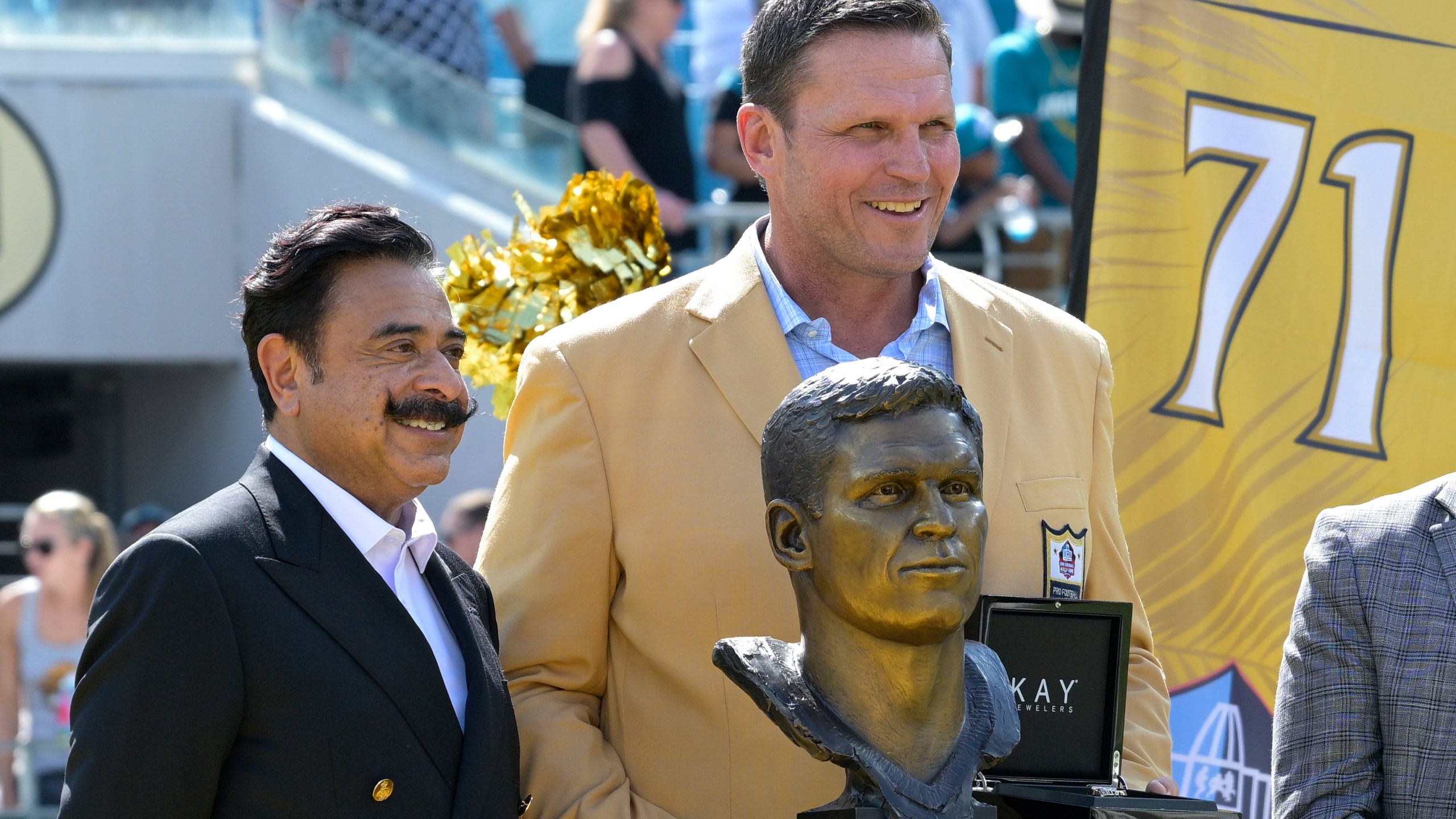 FILE - Former Jacksonville Jaguars lineman Tony Boselli, right, poses while being honored with owner Shad Khan, left, during halftime of an NFL football game against the Houston Texans in Jacksonville, Fla., Sunday, Oct. 9, 2022. (AP Photo/Phelan M. Ebenhack, File)