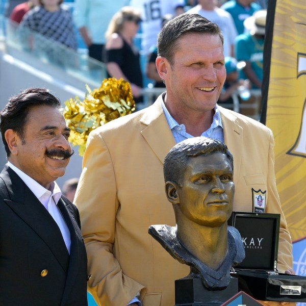 FILE - Former Jacksonville Jaguars lineman Tony Boselli, right, poses while being honored with owner Shad Khan, left, during halftime of an NFL football game against the Houston Texans in Jacksonville, Fla., Sunday, Oct. 9, 2022. (AP Photo/Phelan M. Ebenhack, File)