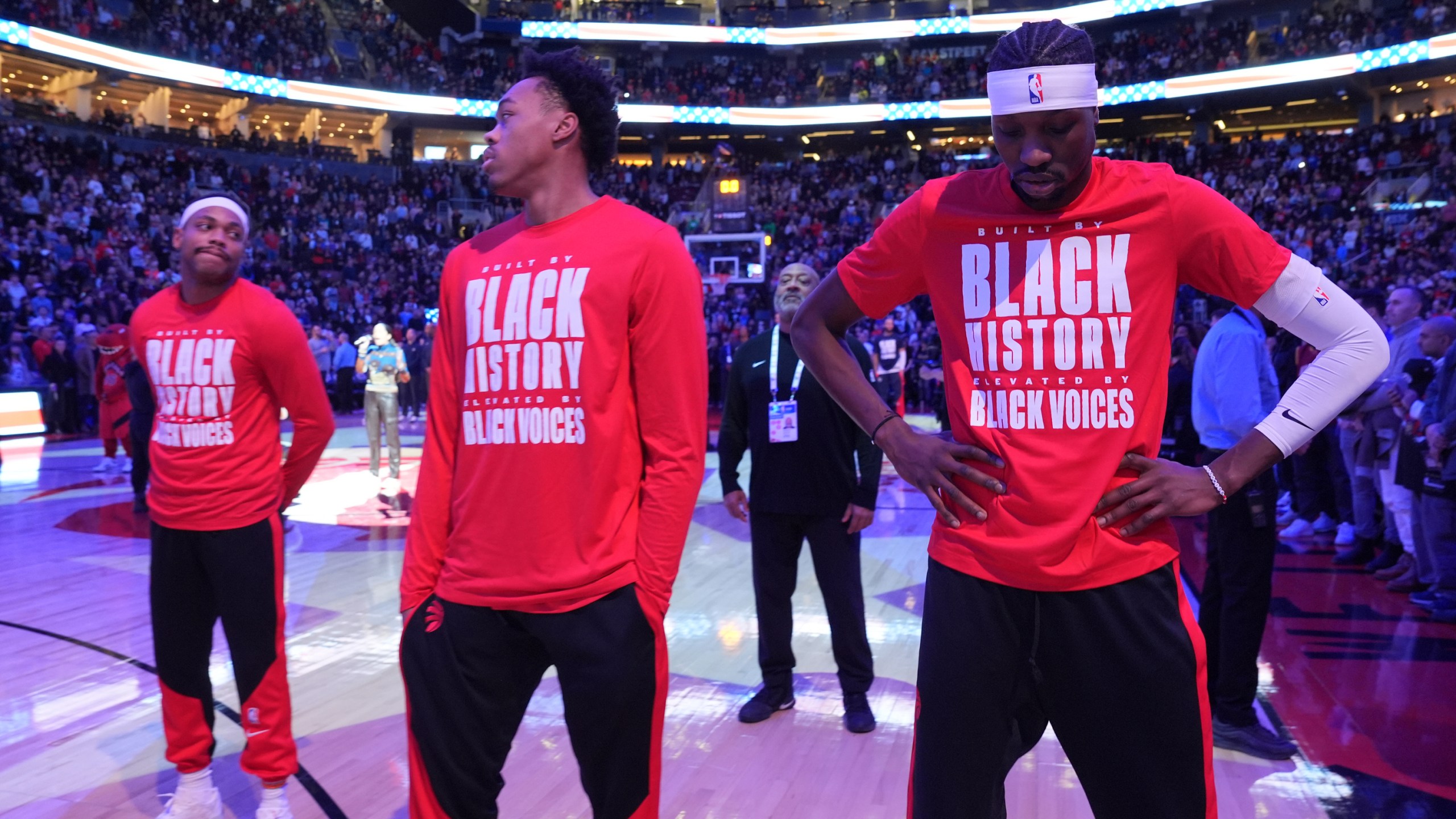 From left to right, Toronto Raptors forwards Bruce Brown, Scottie Barnes and Chris Boucher react as fans boo the United States national anthem before NBA basketball game action against the Los Angeles Clippers in Toronto, Sunday, Feb. 2, 2025. (Frank Gunn/The Canadian Press via AP)