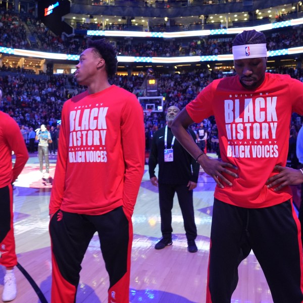 From left to right, Toronto Raptors forwards Bruce Brown, Scottie Barnes and Chris Boucher react as fans boo the United States national anthem before NBA basketball game action against the Los Angeles Clippers in Toronto, Sunday, Feb. 2, 2025. (Frank Gunn/The Canadian Press via AP)