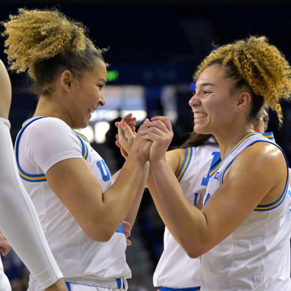 UCLA guards Avary Cain, left, and Kiki Rice, right, celebrate after defeating Minnesota in an NCAA college basketball game Sunday, Feb. 2, 2025, in Los Angeles. (AP Photo/Jayne Kamin-Oncea)