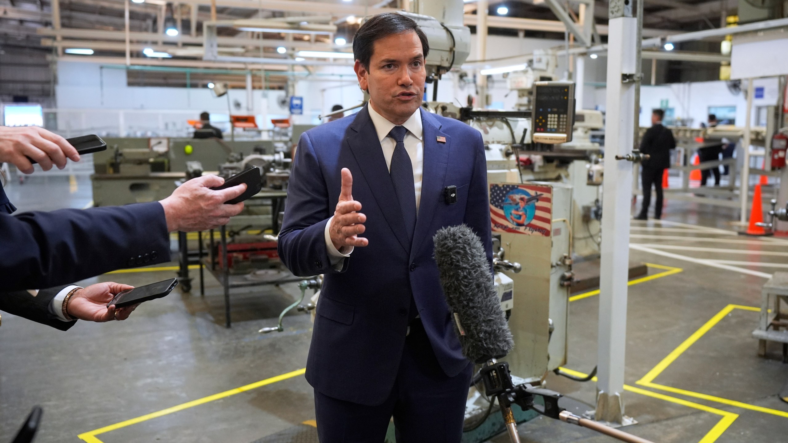 U.S. Secretary of State Marco Rubio speaks to the media during a visit to workshops of aircraft maintenance firm Aeroman in San Luis Talpa, El Salvador, Monday, Feb. 3, 2025. (AP Photo/Mark Schiefelbein, Pool)