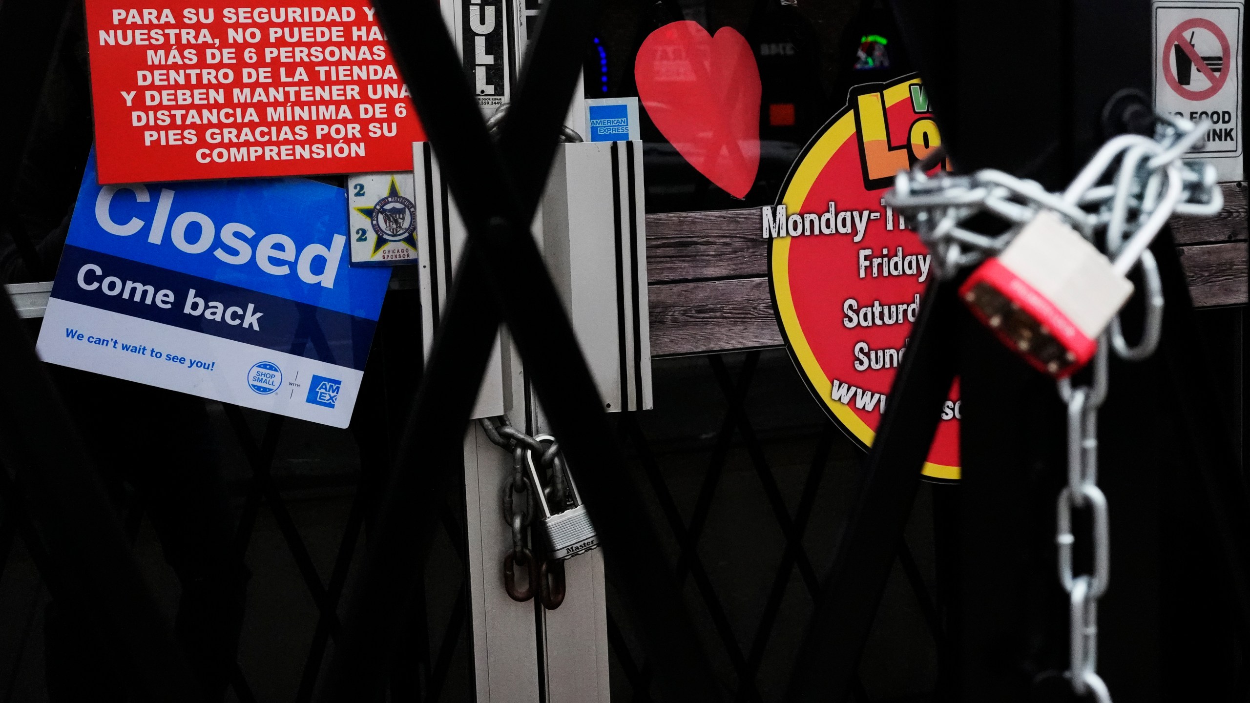 A closed sign is displayed at a mini grocery store in the Little Village neighborhood of Chicago, Monday, Feb. 3, 2025. (AP Photo/Nam Y. Huh)