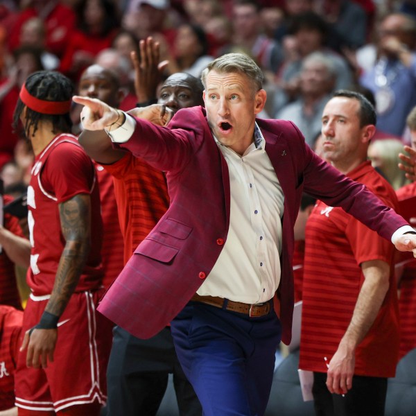 Alabama head coach Nate Oats signals in to his players during the first half of an NCAA college basketball game against Auburn, Saturday, Feb. 15, 2025, in Tuscaloosa, Ala. (AP Photo/Vasha Hunt)