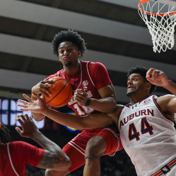 Alabama forward Mouhamed Dioubate (10) rebounds the ball with tight pressure from Auburn's Dylan Cardwell (44) during the first half of an NCAA college basketball game, Saturday, Feb. 15, 2025, in Tuscaloosa, Ala. (AP Photo/Vasha Hunt)