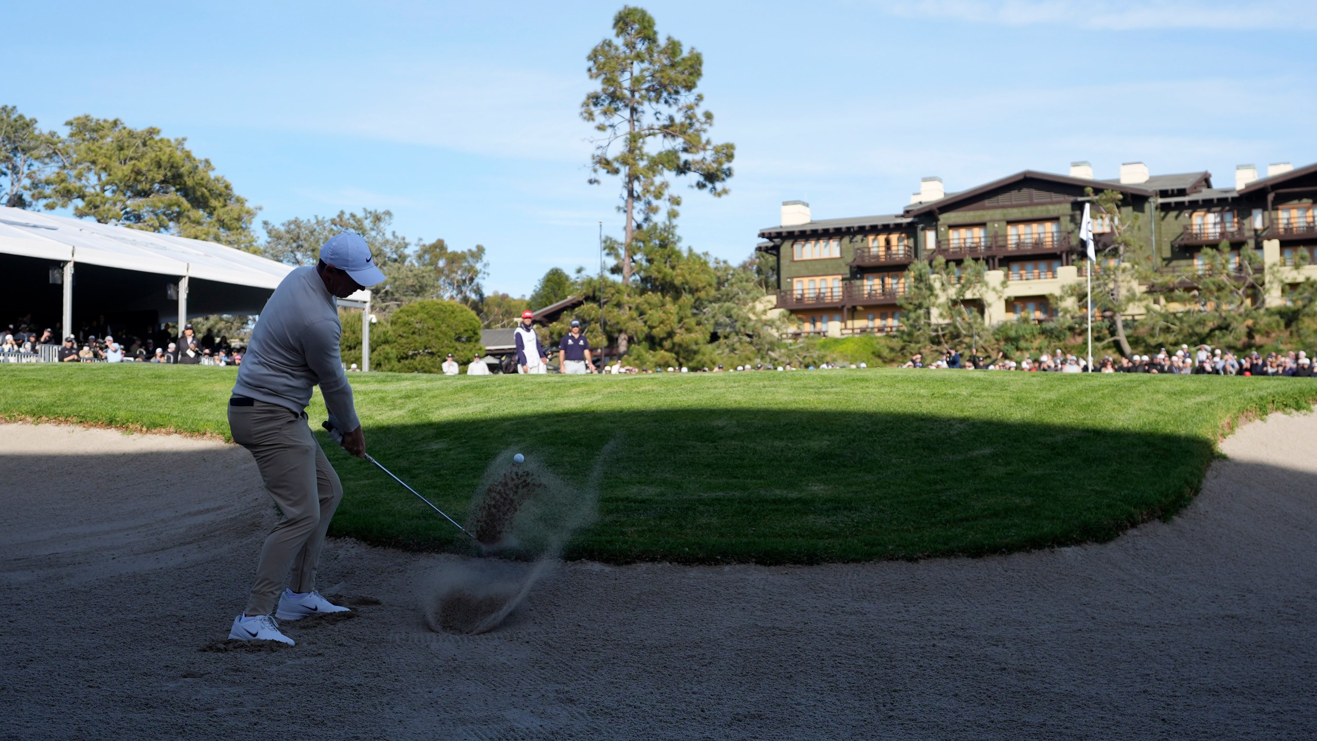 Rory McIlroy, of Northern Ireland, hits out of a bunker on the 18th hole of the South Course at Torrey Pines during the third round of the Genesis Invitational golf tournament Saturday, Feb. 15, 2025, in San Diego. (AP Photo/Gregory Bull)