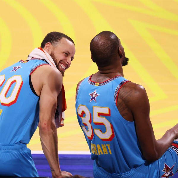 Golden State Warriors guard Stephen Curry talks to Phoenix Suns forward Kevin Durant during the NBA All-Star basketball game Sunday, Feb. 16, 2025, in San Francisco. (AP Photo/Jed Jacobsohn)