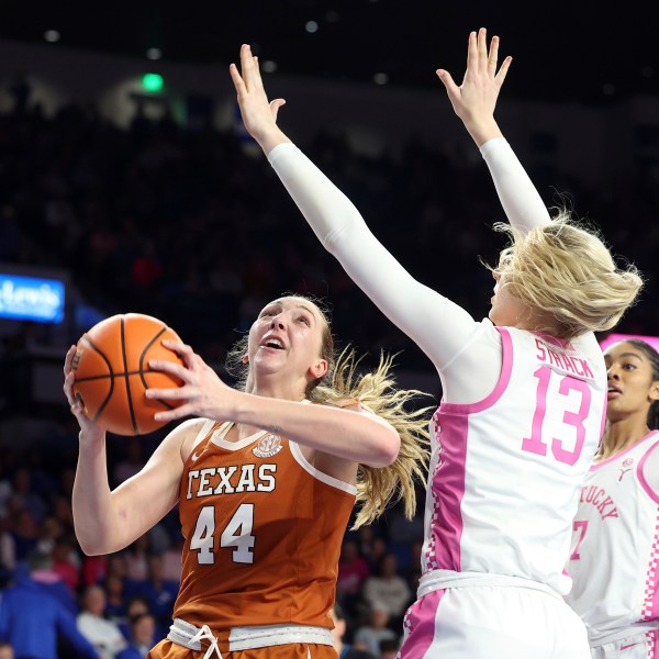 Texas' Taylor Jones (44) shoots while pressured by Kentucky's Clara Strack (13) during an NCAA college basketball game in Lexington, Ky., Thursday, Feb. 13, 2025. (AP Photo/James Crisp)