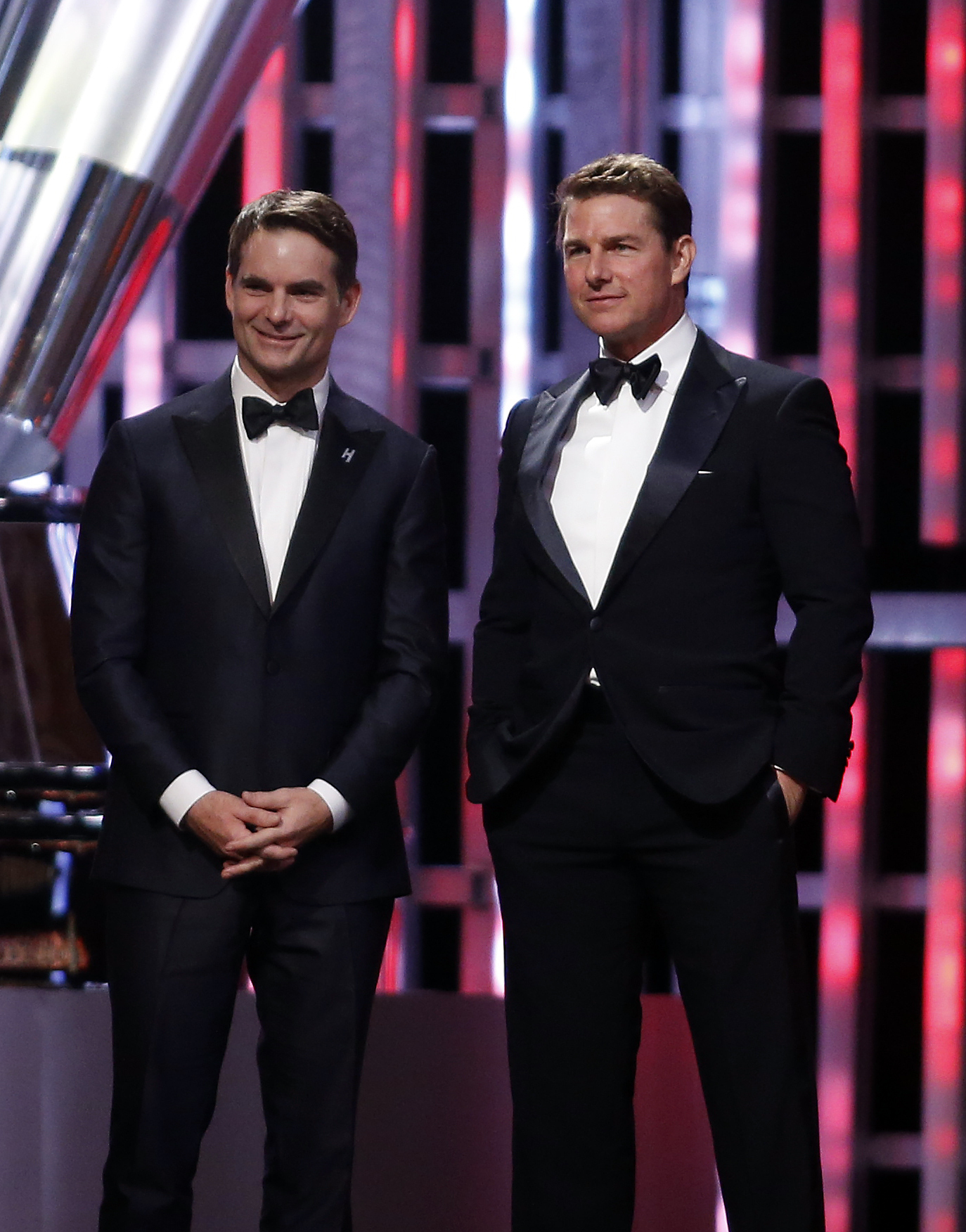 FILE - Jeff Gordon, left, and Tom Cruise listen on stage during the NASCAR Sprint Cup Series auto racing awards, Dec. 4, 2015, in Las Vegas. (AP Photo/Isaac Brekken, file)