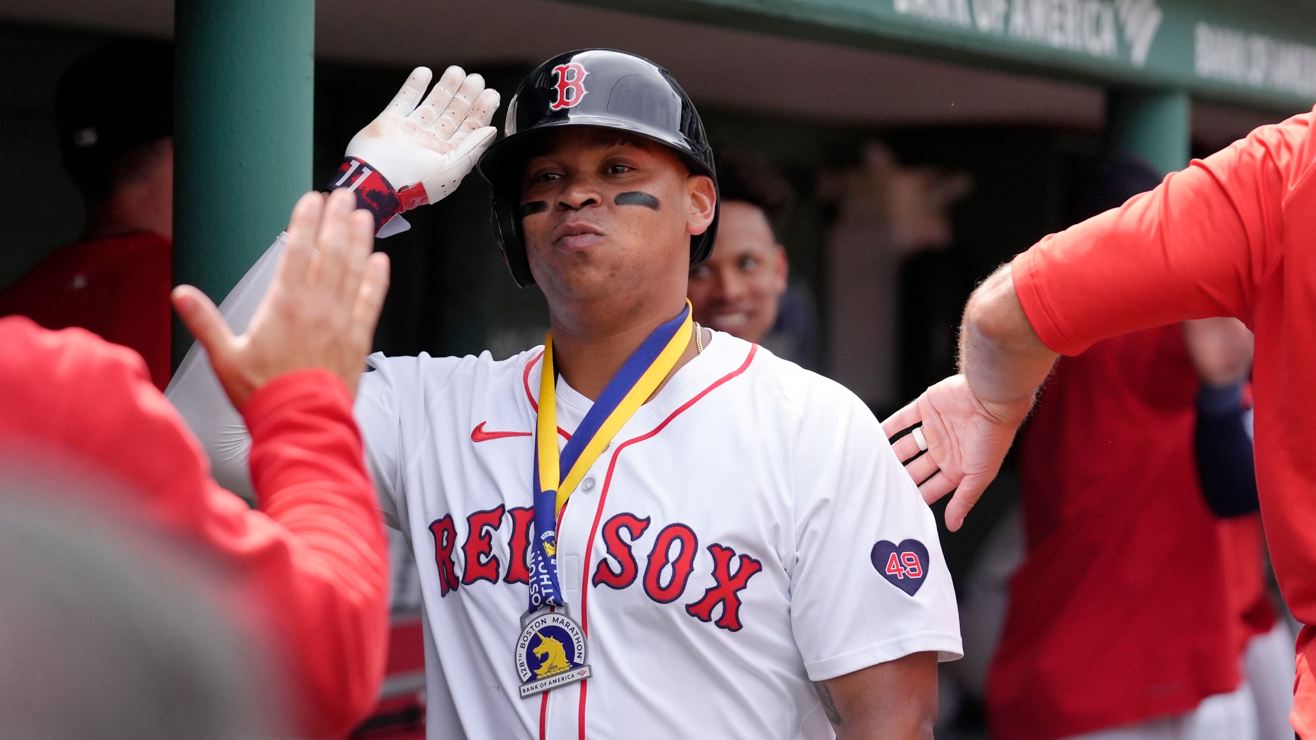 FILE - Boston Red Sox's Rafael Devers celebrates with teammates in the dugout after scoring on his three-run home run the fourth inning of a baseball game against the Arizona Diamondbacks, Aug. 25, 2024, in Boston. (AP Photo/Steven Senne, file)