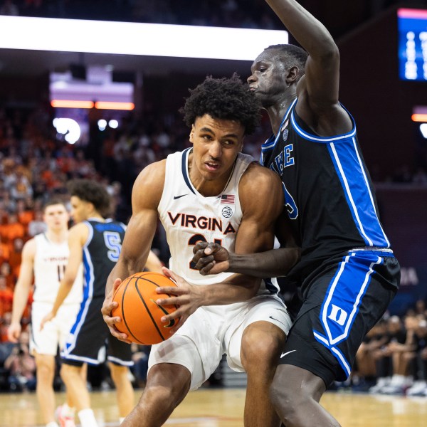 Virginia forward Anthony Robinson defends the ball from Duke center Khaman Maluach during the second half of an NCAA college basketball game, Monday, Feb. 17, 2025, in Charlottesville, Va. (AP Photo/Mike Kropf)