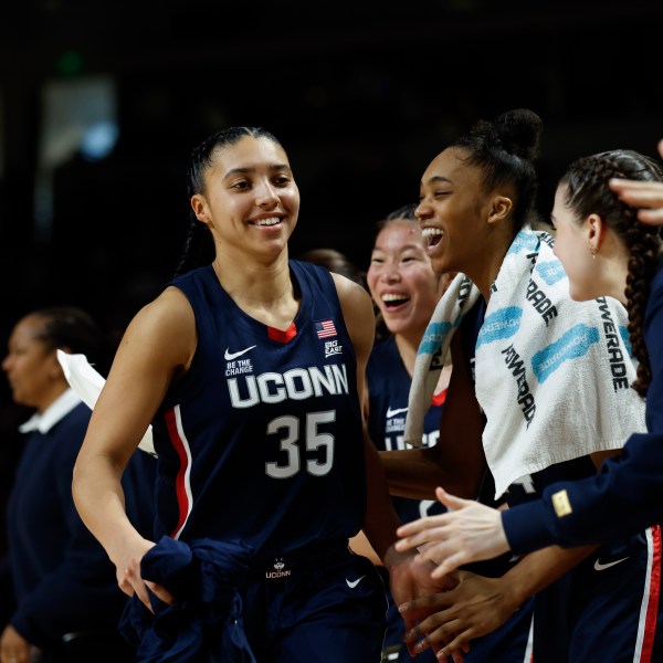 UConn guard Azzi Fudd (35) smiles as she celebrates with teammates on the bench during the second half of an NCAA college basketball game against South Carolina in Columbia, S.C., Sunday, Feb. 16, 2025. (AP Photo/Nell Redmond)