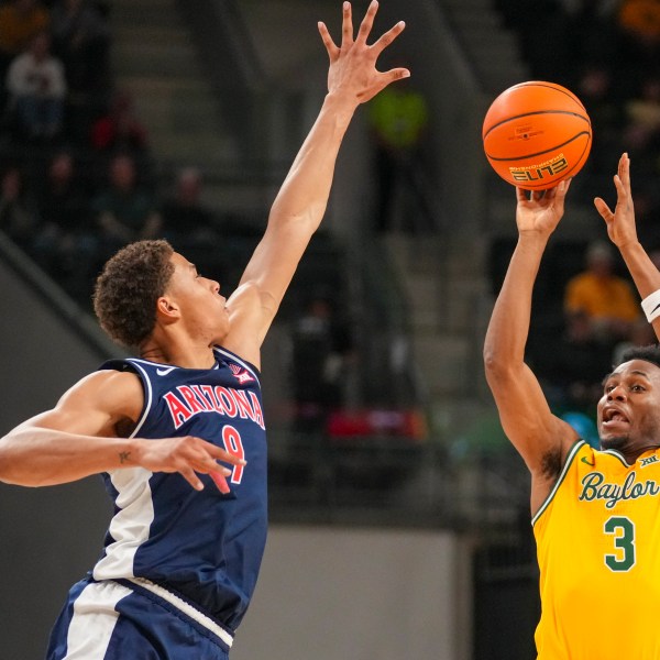 Baylor guard Jeremy Roach (3) shoots against Arizona forward Carter Bryant (9) during the first half of an NCAA college basketball game Monday, Feb. 17, 2025, in Waco, Texas. (AP Photo/Julio Cortez)