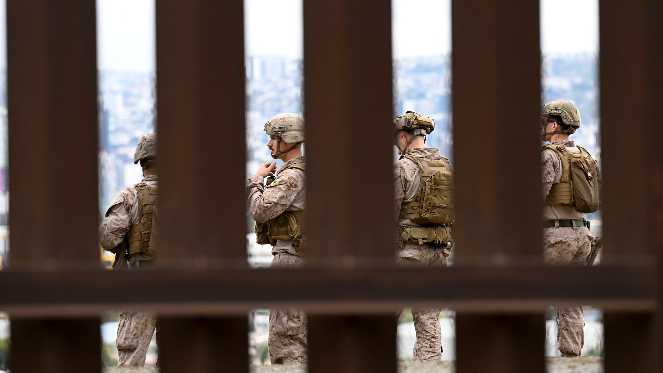 U.S. Marines deploy along the U.S.-Mexico border near the San Ysidro Port of Entry, Friday, Feb. 7, 2025, in San Diego. Tijuana, Mexico in seen in the background. (AP Photo/Denis Poroy)