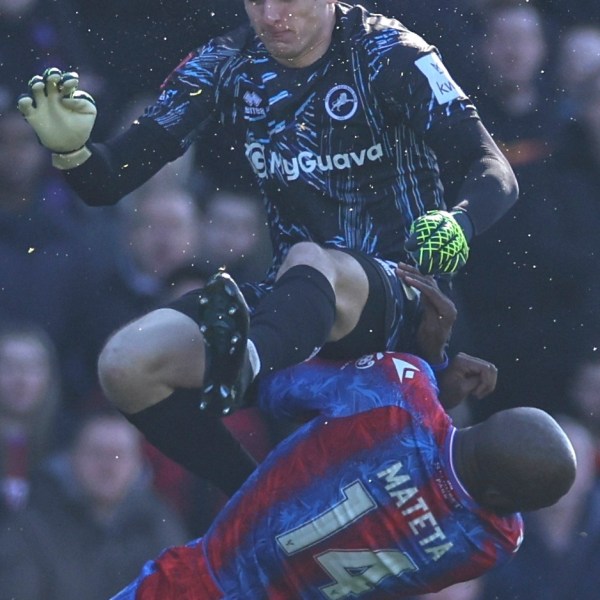 Crystal Palace's Jean-Philippe Mateta is fouled by Millwall goalkeeper Liam Roberts, for which he got a red card, during the English FA Cup soccer match between Crystal Palace and Millwall at Selhurst Park, London, England, Saturday, March 1, 2025. (AP Photo/Ian Walton)