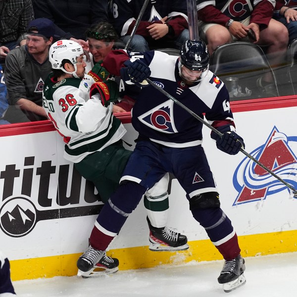 Colorado Avalanche defenseman Calvin de Haan, right, checks Minnesota Wild right wing Mats Zuccarello in the third period of an NHL hockey game Friday, Feb. 28, 2025, in Denver. (AP Photo/David Zalubowski)