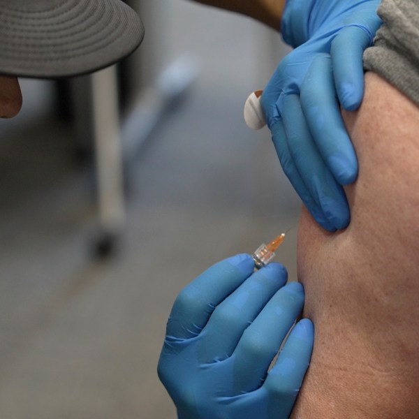 Matt Caldwell, left, a Lubbock Fire Department official, administers a measles, mumps and rubella vaccine to Clair May, 61, at the Lubbock Health Department, Wednesday, Feb. 26, 2025, in Lubbock, Texas. (AP Photo/Mary Conlon)