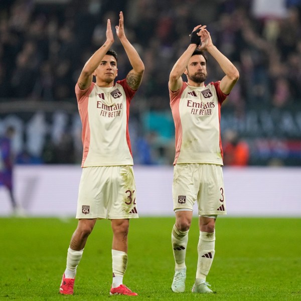 Lyon's Thiago Almada and Nicolas Tagliafico applaud fans at the end of the Europa League round of 16, first leg soccer match between FCSB and Lyon at the National Arena stadium, Thursday, March 6, 2025. (AP Photo/Andreea Alexandru)