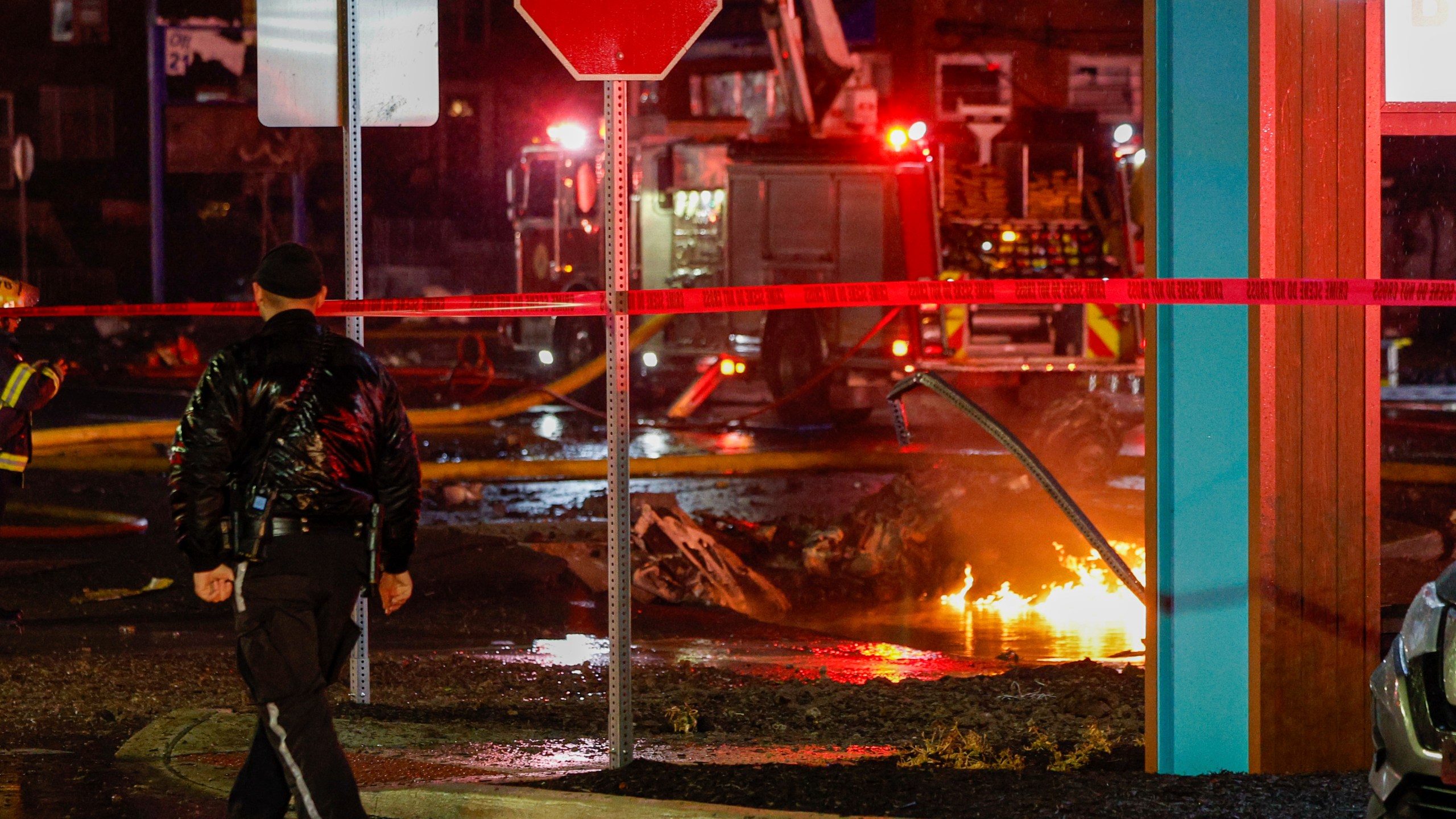 FILE - Fuel burns in the street at Bustleton and Cotton Ave. after a small plane crashed near Roosevelt Mall, Friday, Jan. 31, 2025, in Philadelphia. (Steven M. Falk/The Philadelphia Inquirer via AP, File)