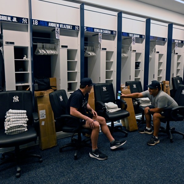 New York Yankees clubhouse attendants wait near the players' lockers during a tour of the upgraded team spring training facilities Thursday, Feb. 13, 2025, at George M. Steinbrenner Field in Tampa, Fla. (AP Photo/Steve Nesius)